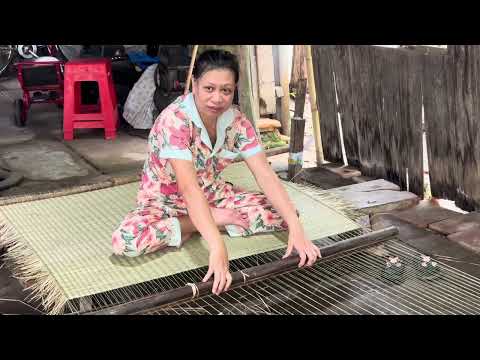 Two Vietnamese women are weaving mats using Bull Rush as raw material, in the Mekong Delta, Vietnam