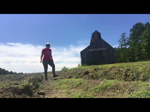 This is me doing some surface searching.   Surface searching is where you walk around and see if anything looks interesting without digging or collecting large amounts in your dry sift or for the wet sift.   I spent a lot of time doing this and found several quartz crystals.  The barn behind me is a part of the original property.