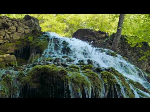 Waterfall flows from Yusupov lake. Sprin