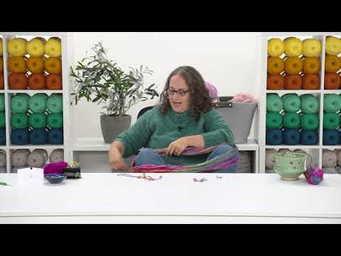 Part of a video titled Winding a Ball from a Hank Without a Swift - YouTube