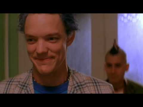 SLC Punk! trailer frame — Stevo and Heroin Bob sprint through downtown Salt Lake City in punk regalia