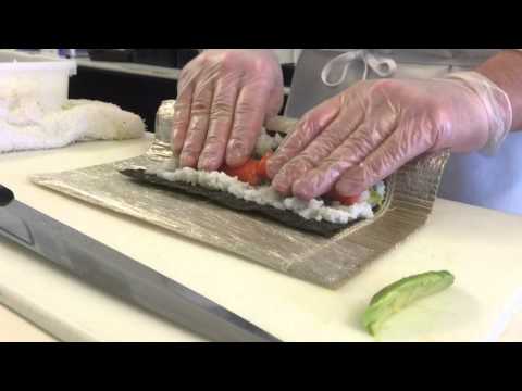 A sushi chef's demonstration of the technique for making a California roll