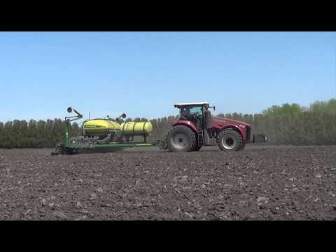 Planting Corn in Iowa with a Deere Planter pulled by a Versatile 290 Tractor