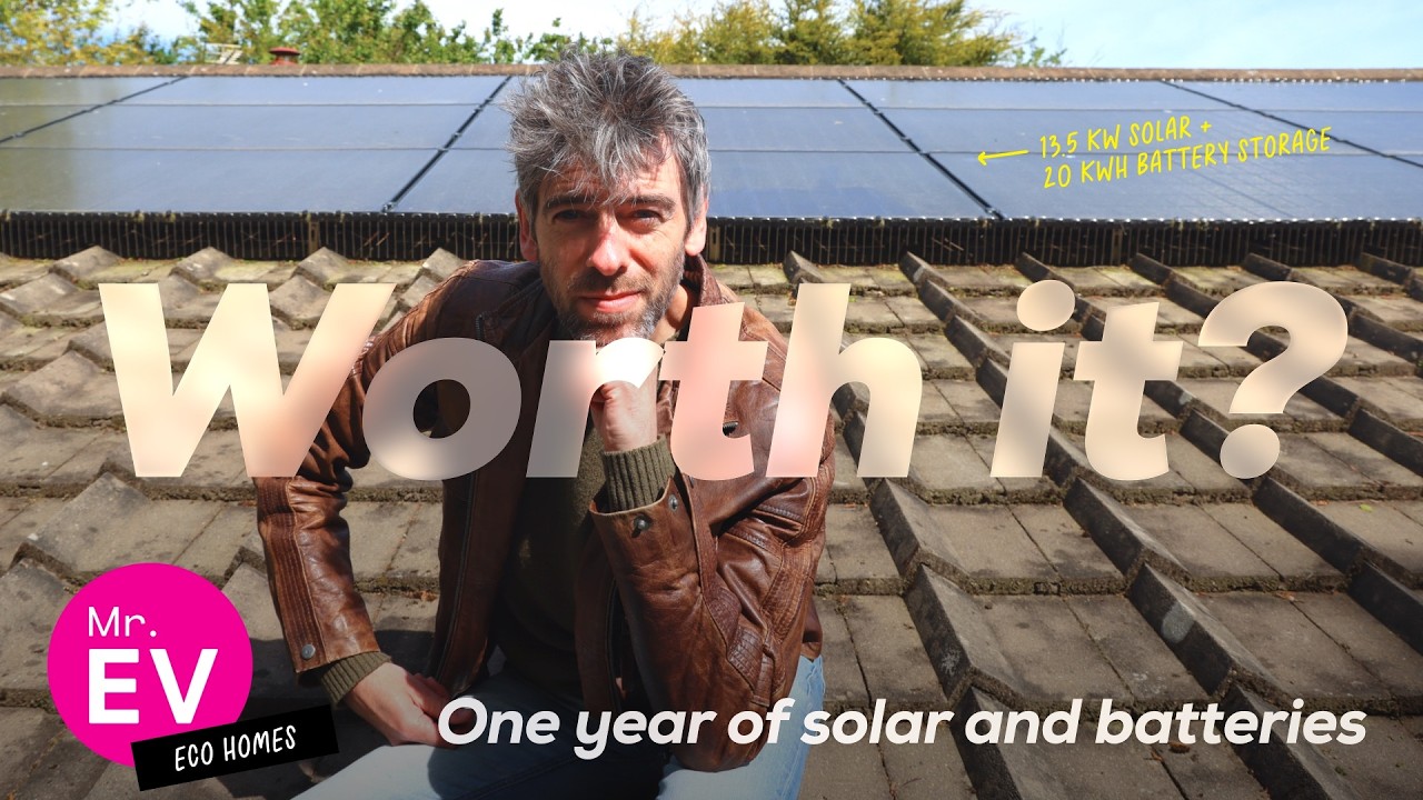 Solar panels installed on a UK residential roof with east-west orientation showing the full 30-panel array alongside two Alpha battery units mounted on an external wall