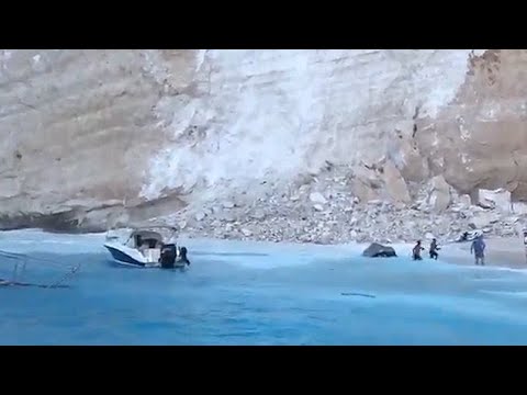 Terrifying moment cliff falls down onto packed beach in Zante as tourists flee