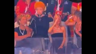 Taylor Swift's guest Ice Spice DEMONIC SIGN gestures while wearing upside down Cross at Super Bowl.