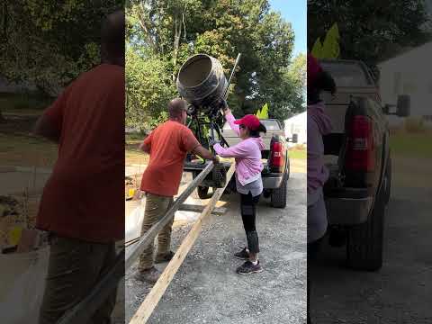 UNLOADING THE CONCRETE/CEMENT MIXER FROM THE TRUCK