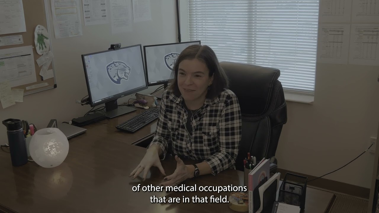 Professor talking to a student in their office