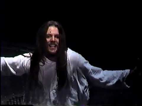 Close-up of the 1996 company in concert formation, microphones and scaffolding in frame