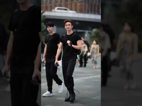Korean street fashion wear men.Cute Boys walking in the street.