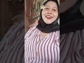 MOTHER IS SELLING AT SCHOOL WHILE WAITING FOR THE CHILDREN TO GO TO SCHOOL