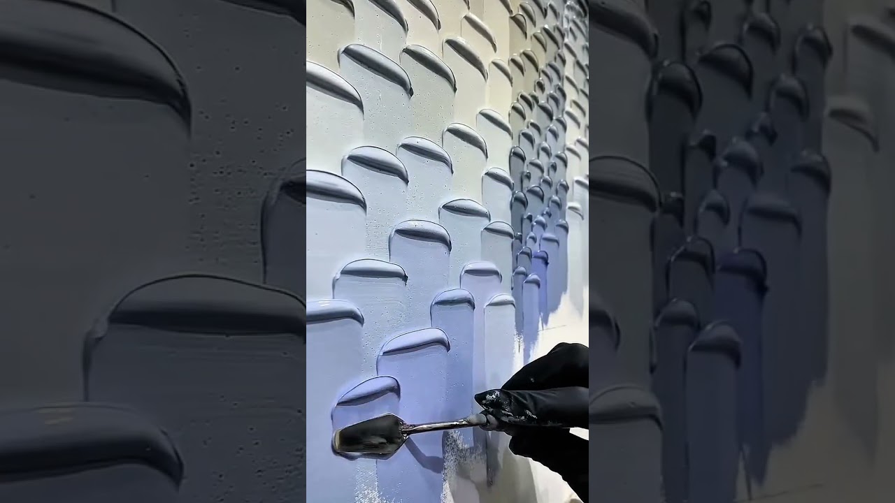 Gloved hand spreads textured blue paint strokes