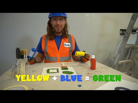 Man in a blue hard hat and orange safety vest demonstrates color mixing: yellow plus blue equals green, with painting supplies on the table.