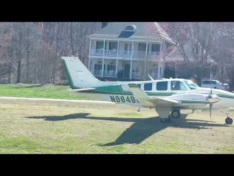 Beechcraft Baron 58 landing on grass runway