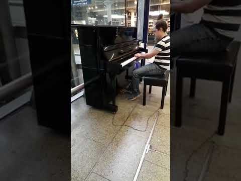 Piano player brings Hallelujah to bustling St Pancras Station London.FIRST time playing in public