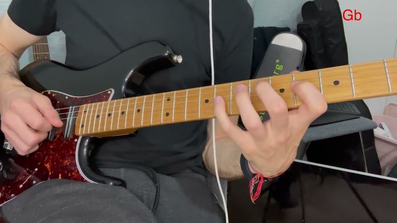 Guitarist demonstrating major and minor sixth intervals as a voice-leading exercise on the fretboard