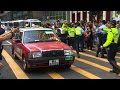 Hong Kong: Cars roll down cleared protests sites.