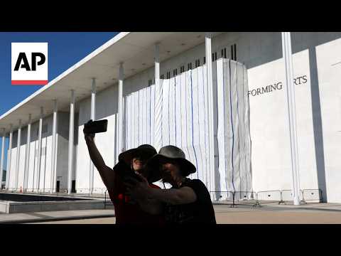Workers remove Trump's name from the Kennedy Center after covering signage