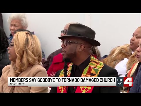 Members of Centennial Christian Church gather for memorial service for the damage building