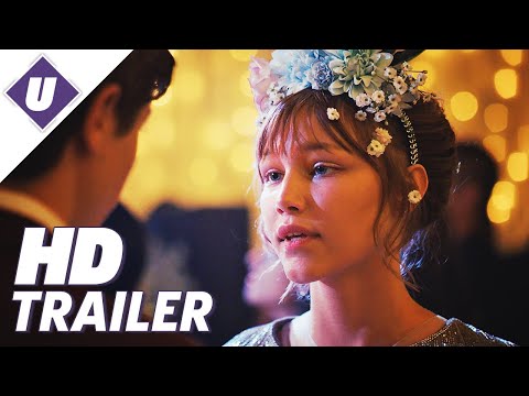 Trailer still: Stargirl strumming ukulele in a school hallway as classmates watch