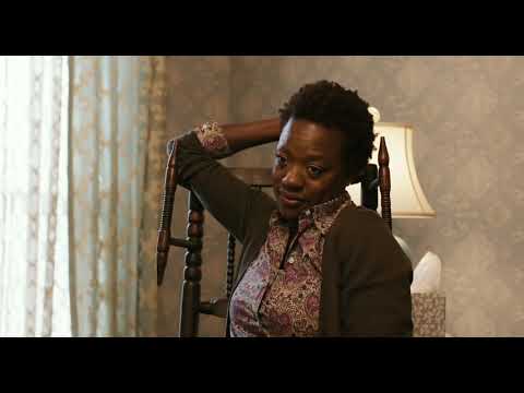 Candlelight vigil: faces in amber, winter breath in the dark, strings like a low prayer