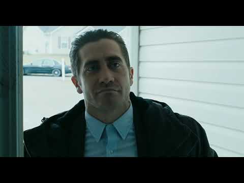 Prisoners 2013 trailer still: rain-streaked windshield, blue-red police wash over Detective Loki