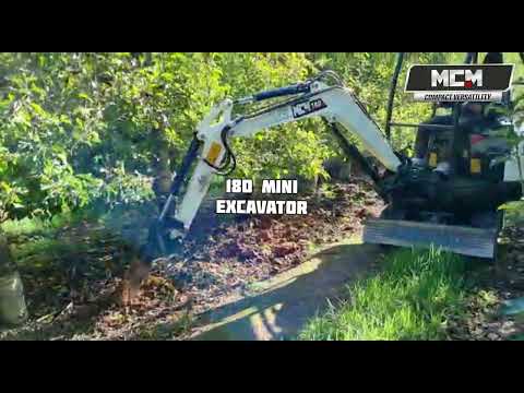18D Mini Excavator Working In Between Fruit Trees
