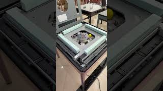 This is an automatic mahjong table, designed to shuffle and stack tiles electronically.
