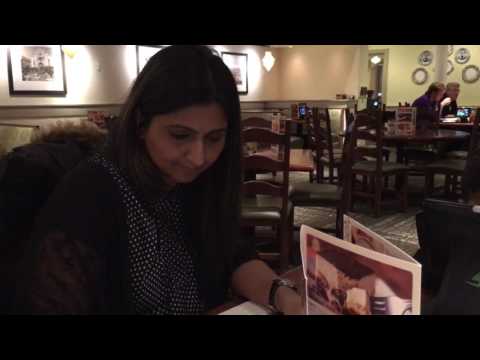 Zara coloring Zuhair playing with tablet at Olive Garden