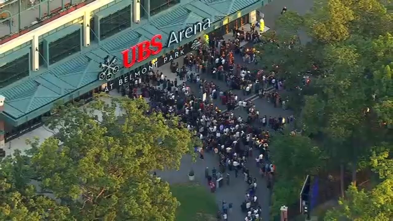 Crowds gather outside of UBS Arena ahead of Dalai Lama visit