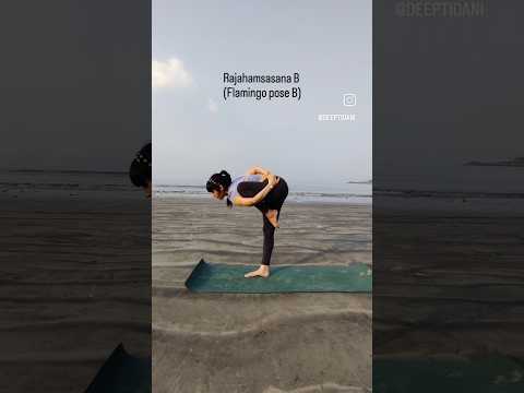 Yoga at the beach. Performing Flamingo pose B
