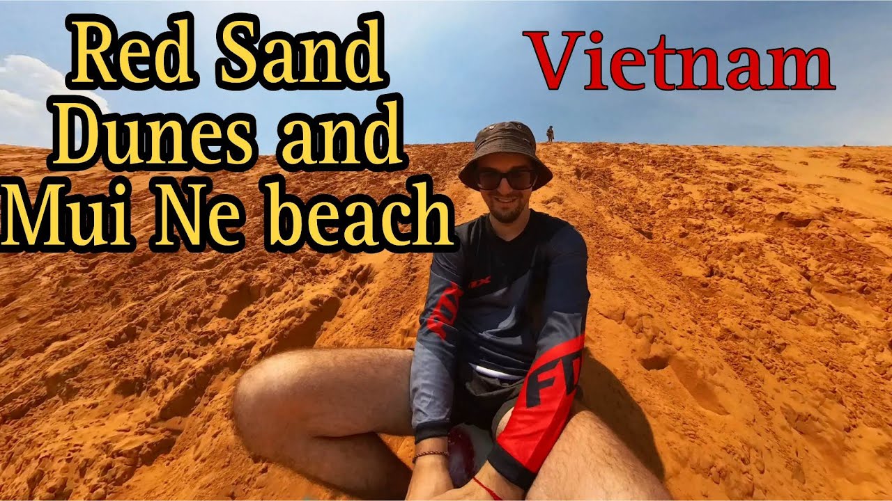 Travelers immerse themselves in the striking allure of Vietnam's vibrant Red Sand Dunes.
