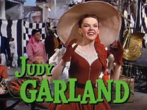 The Pirate trailer third still — Kelly mid-leap in a plaza chorus, the camera craning through Technicolor crowds