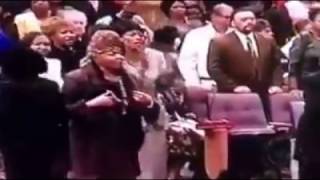 Evangelist Louise Patterson prays for Bishop G.E. Patterson