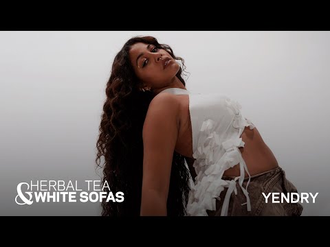 Yendry Reveals The “Spicy” Tour Item That Reminds Her Of Home | Herbal Tea & White Sofas