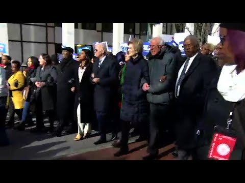 Democratic contenders link arms in MLK Day march Democratic contenders link arms in MLK Day march