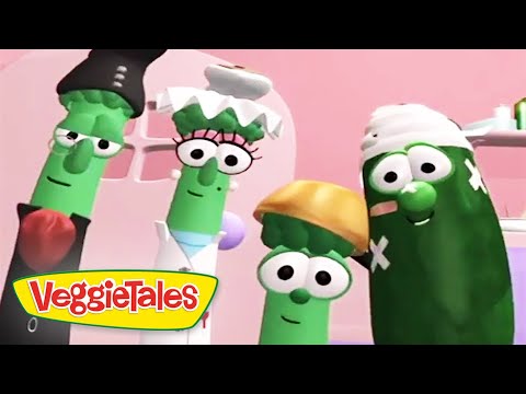 Group of VeggieTales character vegetables posing together in a pink kitchen setting, VeggieTales logo in the corner.