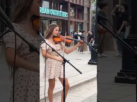 Karolina Protsenko tunes her violin before Stand by Me Violin Cover