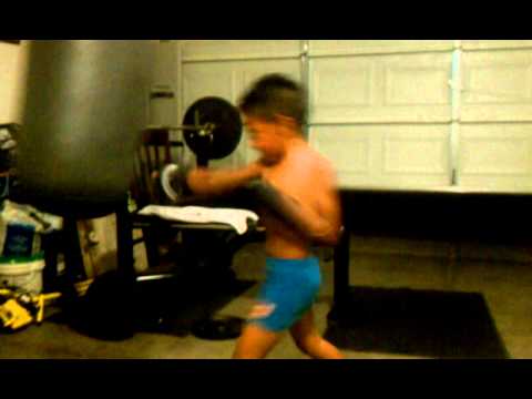 Leonard Romayor Jr. punching the bag at 6ys old