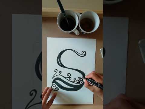 video  risanje inicialke s črnim flomastrom