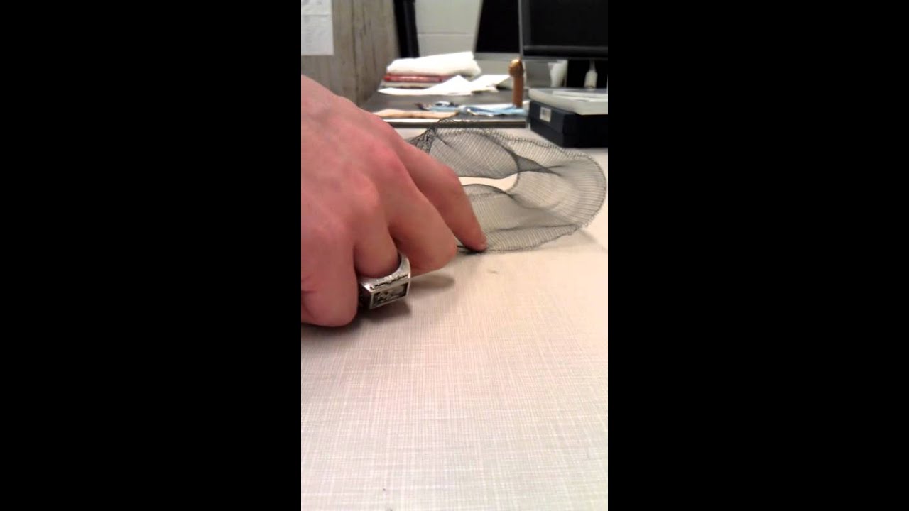 Actuated knit textile containing shape memory alloys (SMAs)