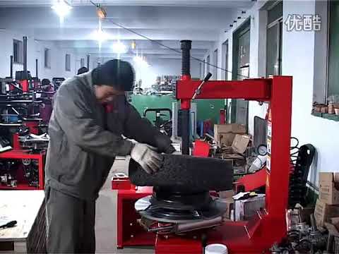 Grilled tire changer with auxiliary arm