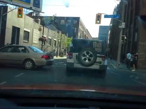 Cyclist kicks my car as I am driving in the driving lane.
