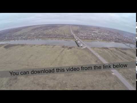 Aerial shot of cars driving on bridge over the river