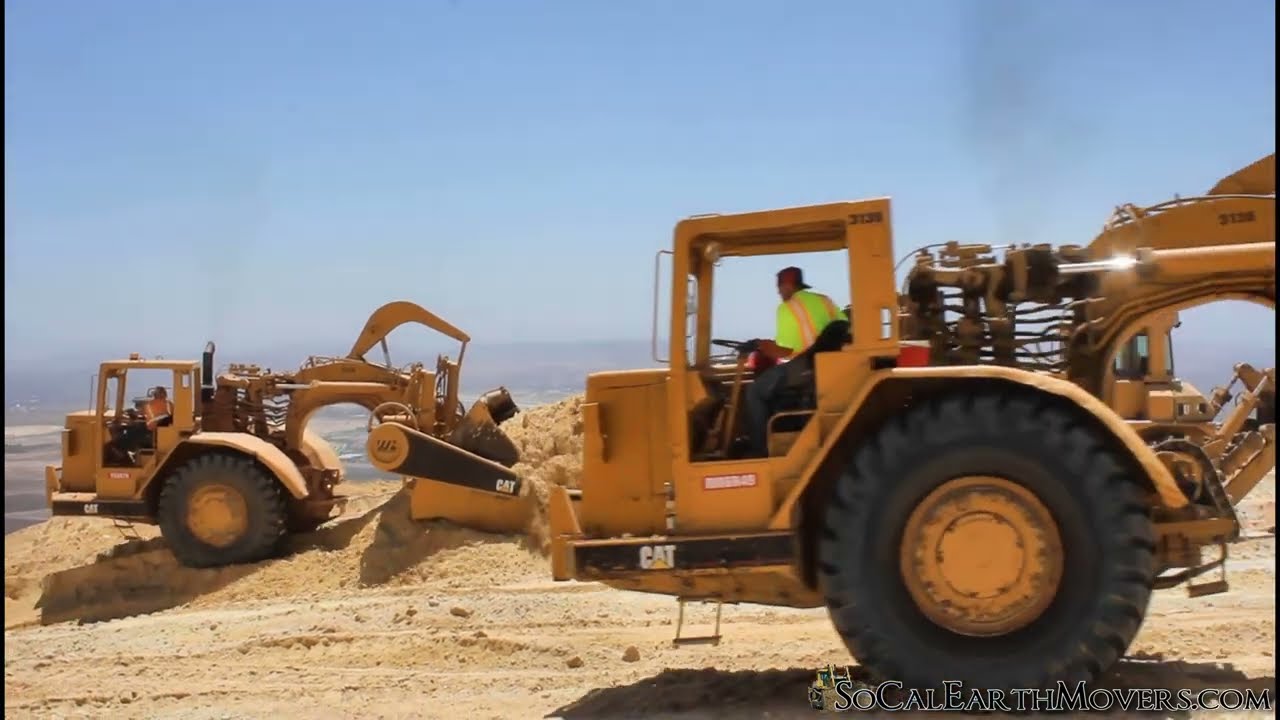 CAT 631D Scrapers being push loaded by D9 Dozers