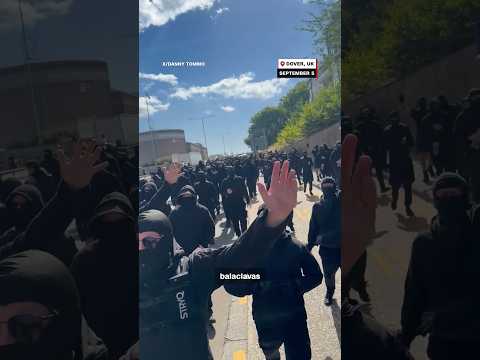 Masked men block roads in anti-immigration protest