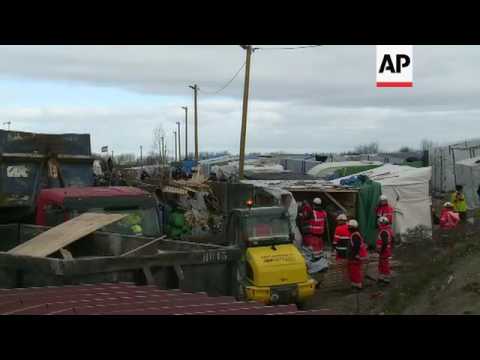 Trucks remove debris from Calais migrants camp