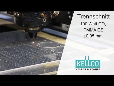 Der Laserschneidkopf eines CO2 Lasers bearbeitet ein Stück gegossenes PLEXIGLAS.