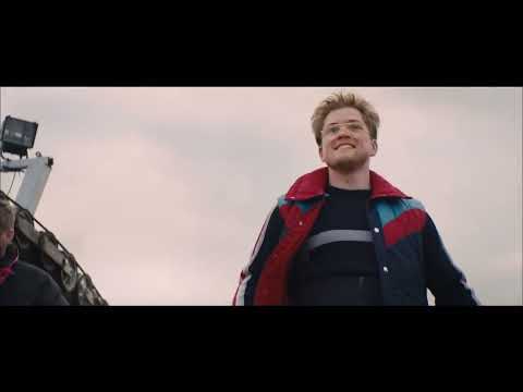 Trailer frame: 90m tower POV; pounding drums set up the leap