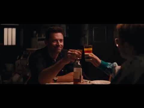 Eddie the Eagle international trailer frame: Eddie in goggles at the top of the jump, synth brass surging